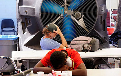 Two people struggling to cool off as the temperature in Phoenix hits 110 degrees